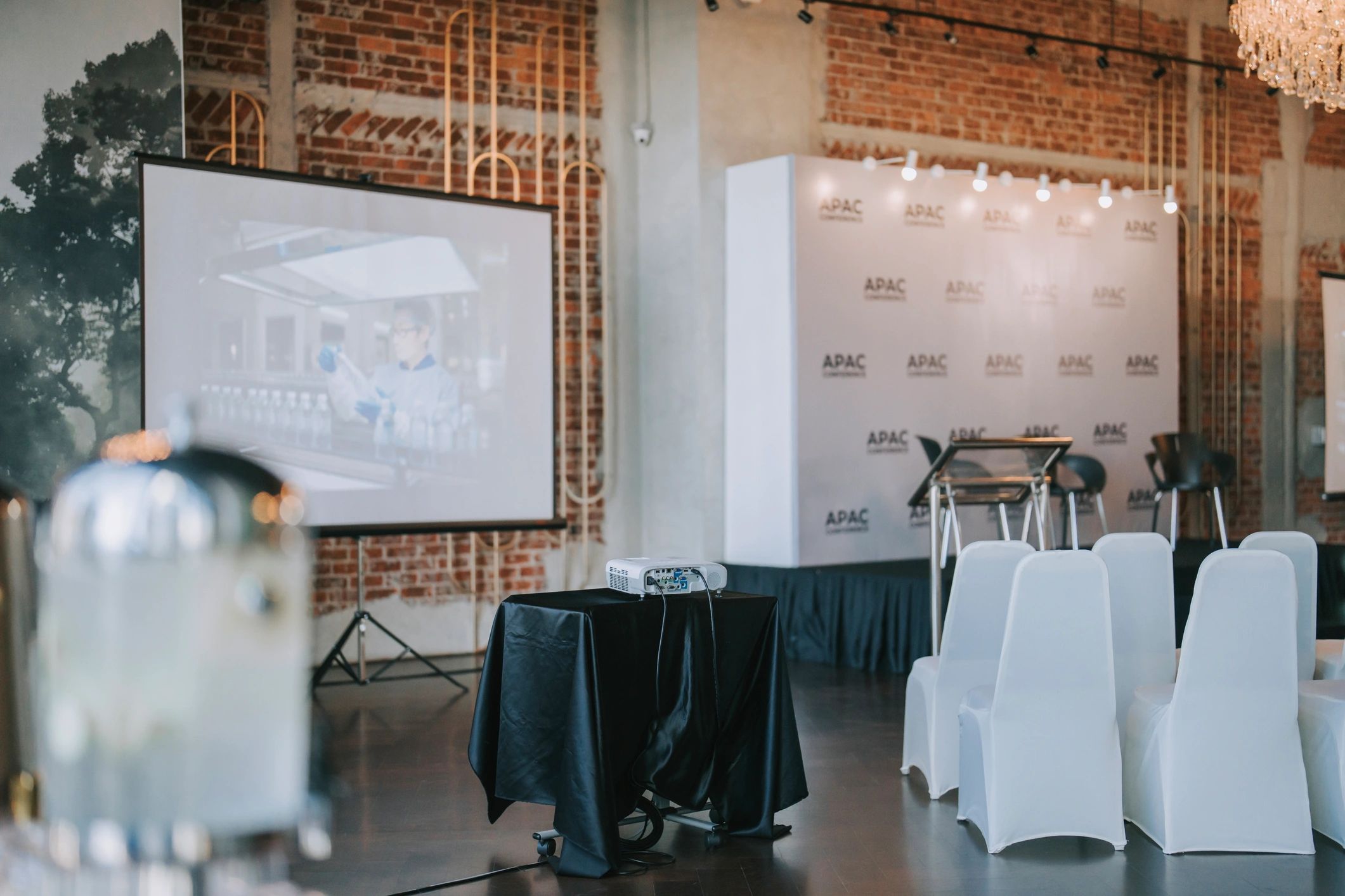 Event stage with projector screen and seating