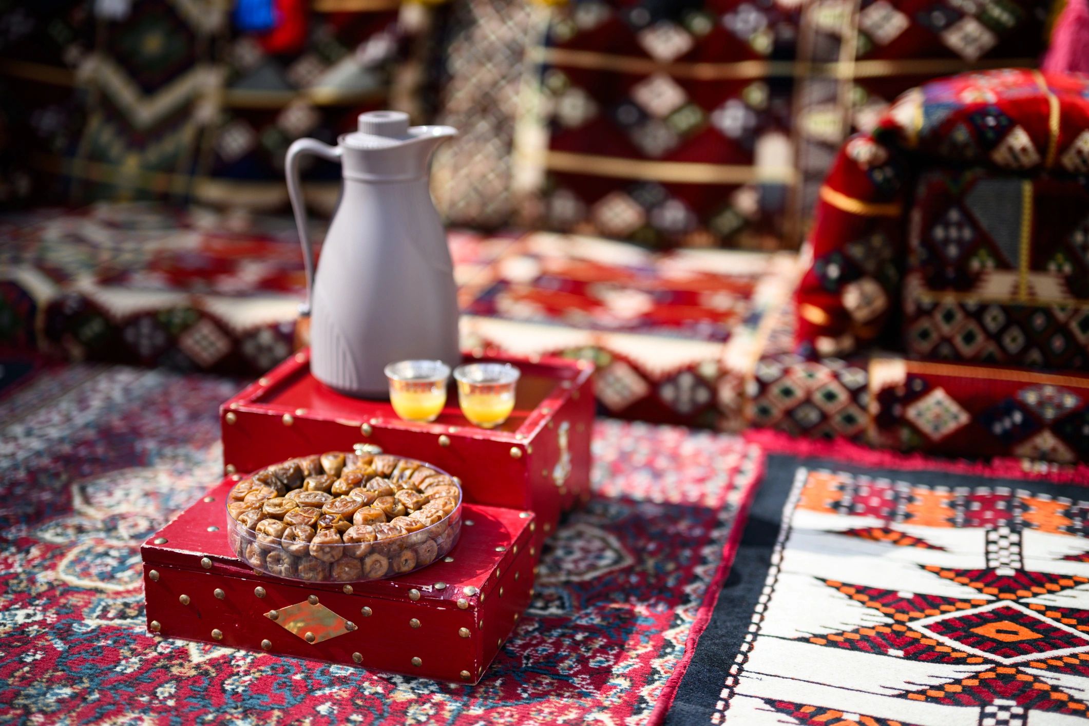 Traditional majlis hospitality setup with seating and serving table